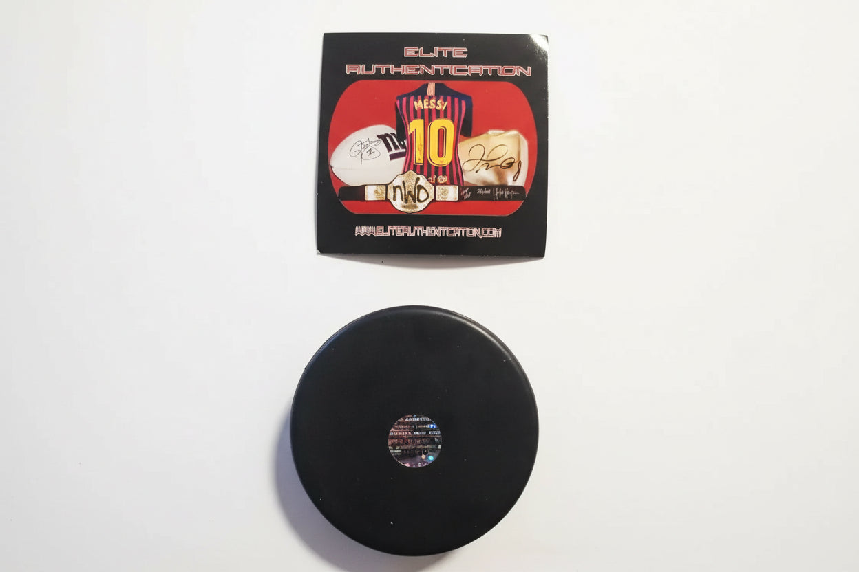 Back of Emilio Estevez signed Mighty Ducks hockey puck showing authentication hologram